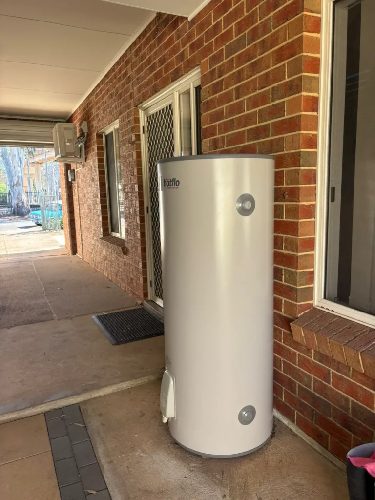 Professional outdoor installation of a high-efficiency electric hot water storage tank on an Adelaide residential property.
