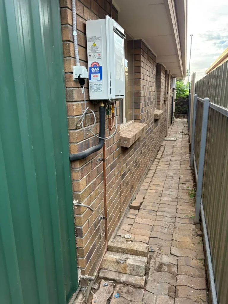 Hot water system on brick wall adelaide